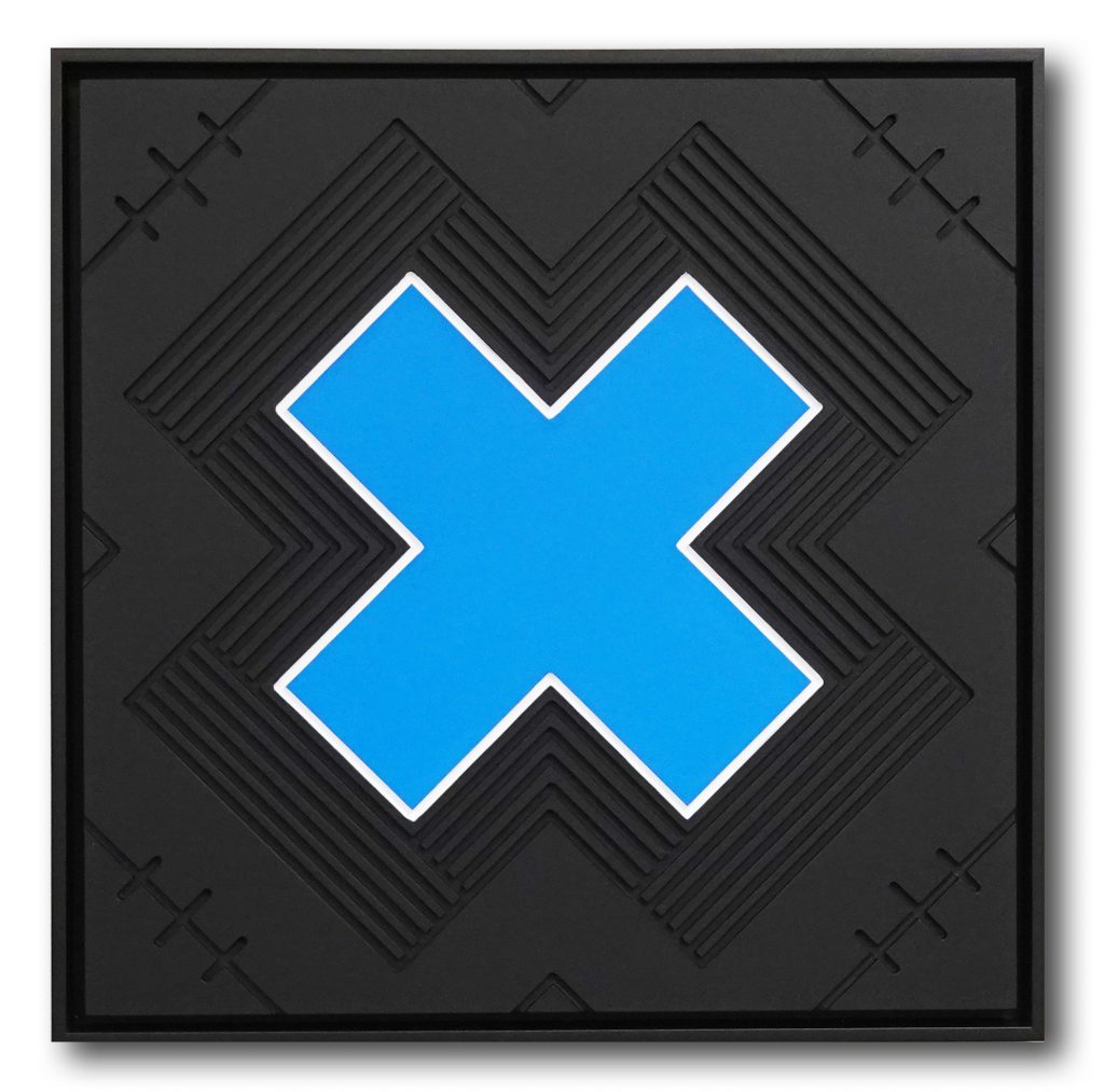 The letter X, carved in wood, blue X with black stripes in background